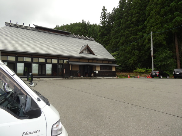 のどか村の建物外観と停めた軽キャンピングカー